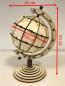 Preview: Earth globe with axis and rotating bracket in segment technology 